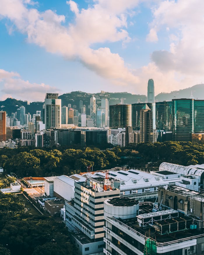 about-03 A vibrant cityscape showcasing Hong Kong Island's skyline with iconic skyscrapers and lush greenery.