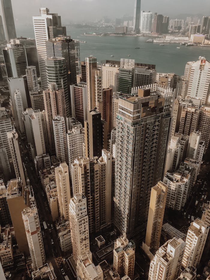 why-choose-us-02 Drone view of contemporary city with skyscrapers and high rise buildings near river